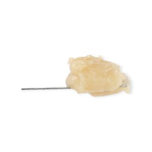 Tractor Fuel THCa Rosin in a glass jar with golden, glossy texture