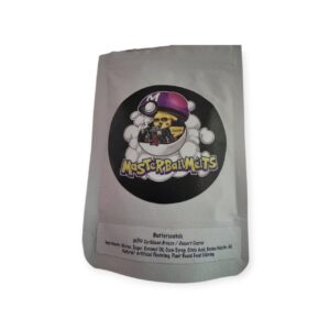 Close-up of Butterscotch Cozy Cubes x Master Ball Melts THC gummies in golden wrappers with creamy texture and rosin label